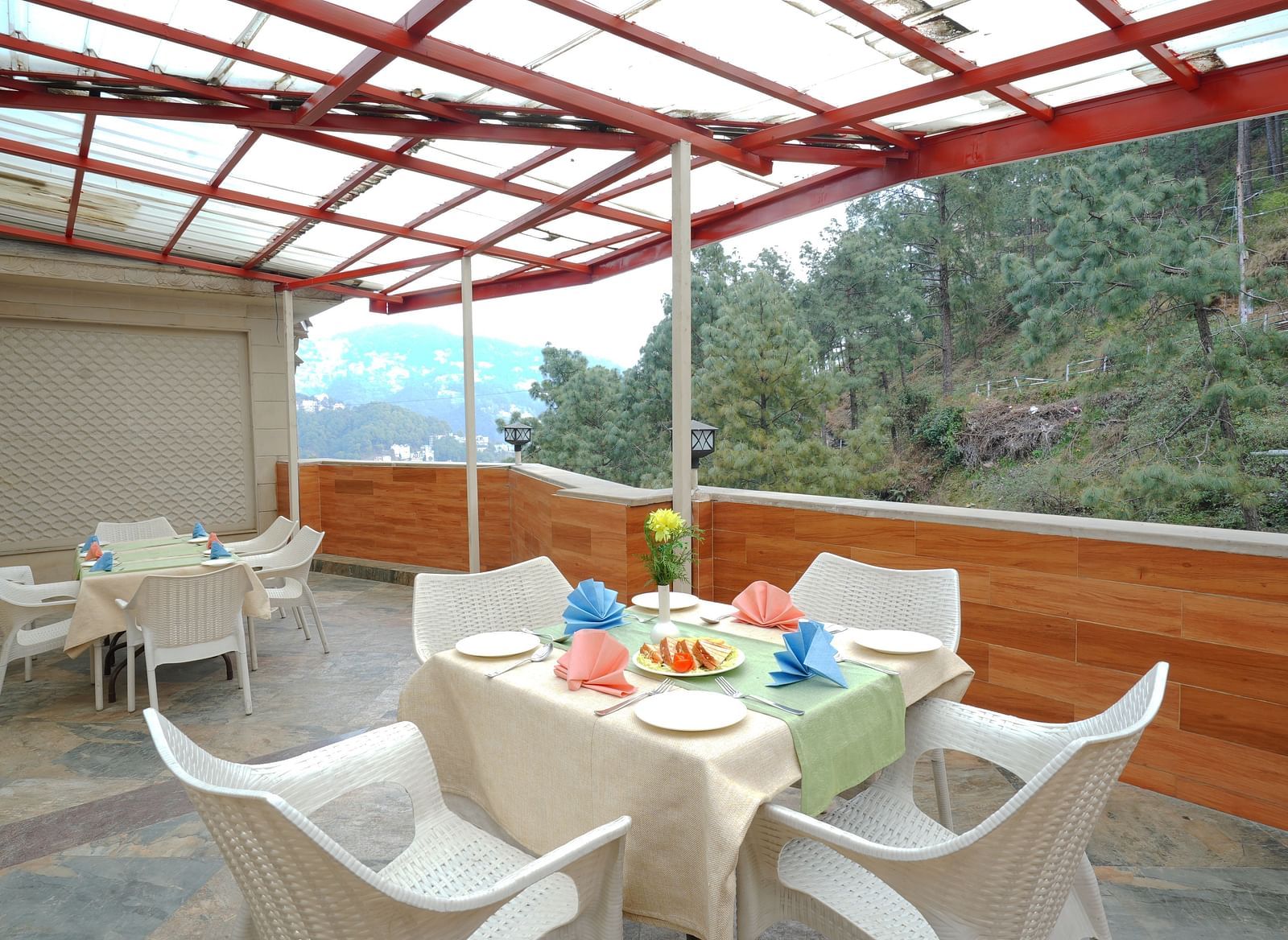 Dining setup on the terrace with cutlery placed on the table at DLS Hotels The Rock Castle.